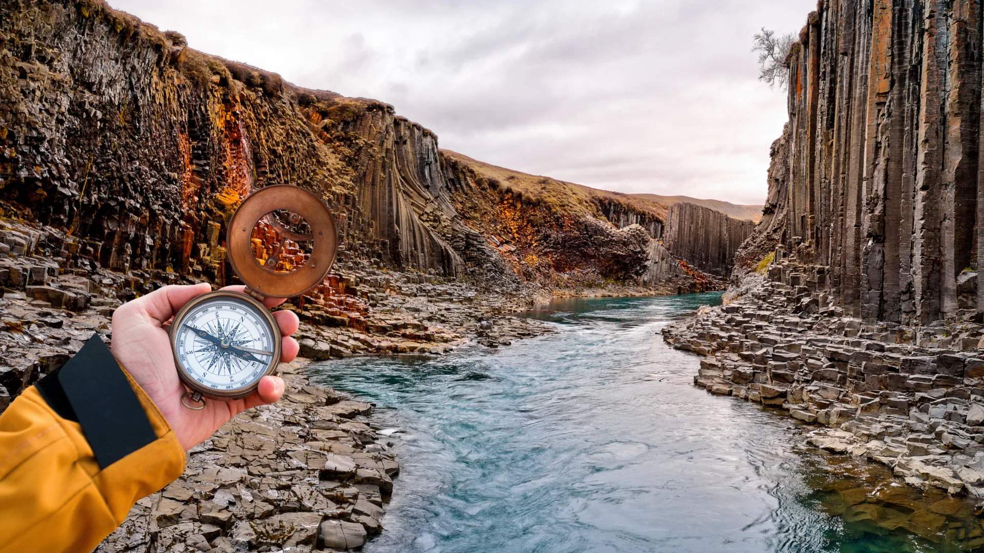 Beautiful landscape with old compass on traveler's hand. Traveling concept.